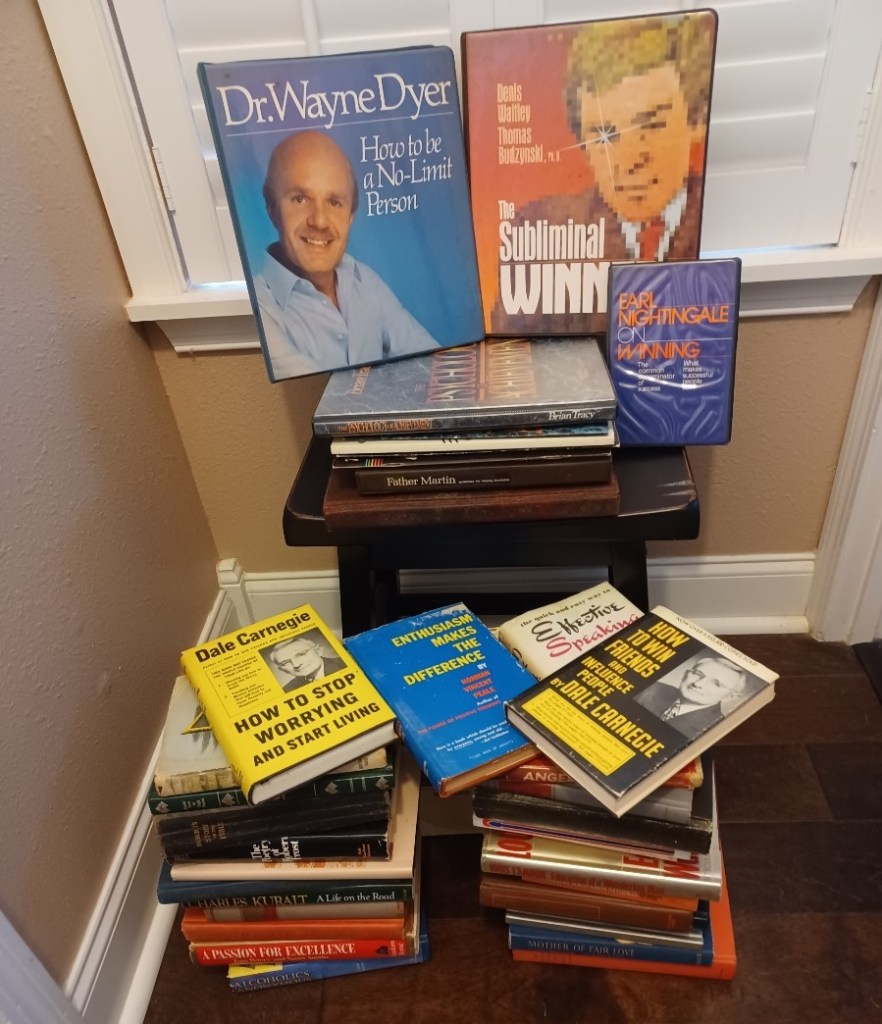 Dad's multiple stacks of self-improvement books.