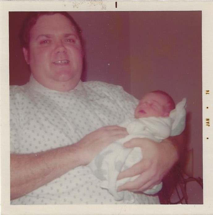 Dad holding me as a newborn, January 1974.